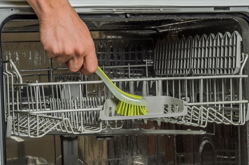 how to clean a dishwasher - scrub the racks too