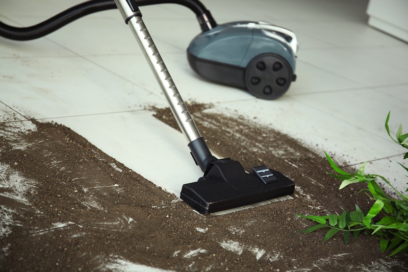 Vacuum cleaning after falling flower pot on a tiled floor
