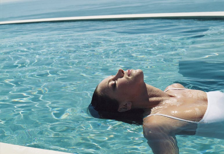 woman relaxing in clean vacuumed pool