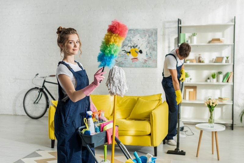 commercial vacuum buying guide - house cleaners dusting and  vacuuming